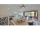 Cozy living room featuring stylish furnishings, a ceiling fan, and a serene view of the backyard at 111 Brown Crane Ct, Daytona Beach, FL 32119