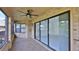 The screened patio features a ceiling fan, brick supports and a sliding glass door at 111 Brown Crane Ct, Daytona Beach, FL 32119