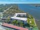 Aerial view of waterfront condo featuring a pool, tennis court, and scenic water views at 1224 S Peninsula Dr # 210, Daytona Beach, FL 32118