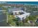 Overhead shot of a waterfront condo complex boasting a swimming pool, tennis court, and green spaces at 1224 S Peninsula Dr # 210, Daytona Beach, FL 32118