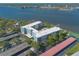 Aerial view of a modern building overlooking a beautiful waterfront and bridge at 1224 S Peninsula Dr # 210, Daytona Beach, FL 32118