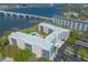 Modern building with pool, parking, landscaping, and a bridge in the background at 1224 S Peninsula Dr # 210, Daytona Beach, FL 32118