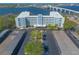 A modern building with covered parking, landscaping, and a bridge in the background at 1224 S Peninsula Dr # 210, Daytona Beach, FL 32118