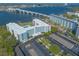 Modern building with pool, parking, landscaping, and a bridge in the background at 1224 S Peninsula Dr # 210, Daytona Beach, FL 32118