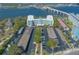 A modern building with covered parking, landscaping, and a bridge in the background at 1224 S Peninsula Dr # 210, Daytona Beach, FL 32118