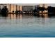 Waterfront condo complex reflected in the calm water, showcasing its multiple stories and serene setting at 1224 S Peninsula Dr # 210, Daytona Beach, FL 32118