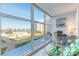 Bright Florida room featuring floor-to-ceiling windows with views of the waterfront and tropical landscaping at 1224 S Peninsula Dr # 210, Daytona Beach, FL 32118