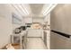 Compact kitchen with white cabinetry, modern appliances, and a convenient breakfast bar area for dining at 1224 S Peninsula Dr # 210, Daytona Beach, FL 32118