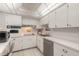Well-lit kitchen featuring white cabinets, quartz countertops, and stainless steel appliances at 1224 S Peninsula Dr # 210, Daytona Beach, FL 32118