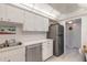 Functional kitchen with stainless steel appliances, white cabinets, and easy-to-clean laminate flooring at 1224 S Peninsula Dr # 210, Daytona Beach, FL 32118
