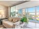 Bright sunroom with floor-to-ceiling windows offering beautiful water views and comfortable seating at 1224 S Peninsula Dr # 210, Daytona Beach, FL 32118