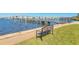 Waterfront view with a bench overlooking a pier and bridge, ideal for relaxation and enjoying the scenery at 1224 S Peninsula Dr # 210, Daytona Beach, FL 32118