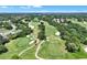 Scenic aerial view of a lush golf course surrounded by trees near residences at 1329 N Old Mill Dr, Deltona, FL 32725