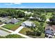 Aerial view of a beautiful home with a well-manicured lawn near lush green space at 1329 N Old Mill Dr, Deltona, FL 32725