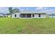 Spacious backyard featuring a screened patio and ample green space at 1329 N Old Mill Dr, Deltona, FL 32725