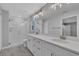 Bright bathroom featuring a double vanity, quartz counters, walk-in shower, and contemporary fixtures at 1329 N Old Mill Dr, Deltona, FL 32725
