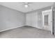 Bedroom boasts neutral carpet, a ceiling fan, fresh paint, and an abundance of natural light at 1329 N Old Mill Dr, Deltona, FL 32725