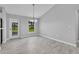 Bright dining area with modern chandelier, ceramic tile floors, and access to the backyard at 1329 N Old Mill Dr, Deltona, FL 32725