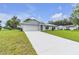 Well-maintained home with an attached garage and a long driveway at 1329 N Old Mill Dr, Deltona, FL 32725