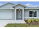Inviting entryway showcasing the front door and well-manicured landscaping at 1329 N Old Mill Dr, Deltona, FL 32725