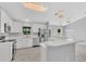 Modern kitchen with stainless steel appliances, white cabinets, quartz countertops, and a breakfast bar at 1329 N Old Mill Dr, Deltona, FL 32725