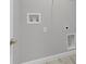 Bright laundry room with gray walls, white trim, and modern hookups at 1329 N Old Mill Dr, Deltona, FL 32725