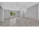 Spacious living room with vaulted ceilings and modern tile flooring at 1329 N Old Mill Dr, Deltona, FL 32725