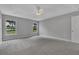 Large carpeted main bedroom with tray ceiling, and ample natural light at 1329 N Old Mill Dr, Deltona, FL 32725
