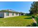 This backyard features a well-manicured lawn, garden bed, and a view of neighboring properties at 1423 Chelsea Manor Cir, Deland, FL 32724