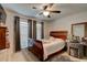 Cozy bedroom featuring carpet, ceiling fan, and a large window for natural light at 1423 Chelsea Manor Cir, Deland, FL 32724