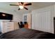 Comfortable bedroom with large closet, ceiling fan and mounted TV on the dresser at 1423 Chelsea Manor Cir, Deland, FL 32724