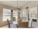 Cozy breakfast nook with a glass top round table, surrounded by lots of natural light for relaxed morning meals at 1423 Chelsea Manor Cir, Deland, FL 32724