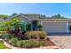 Charming single-story home with brick driveway and meticulously landscaped front yard at 1423 Chelsea Manor Cir, Deland, FL 32724