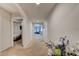 Long hallway leading to various rooms, carpeted with neutral paint and arched doorways at 1423 Chelsea Manor Cir, Deland, FL 32724