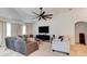Spacious living room featuring comfortable seating, a large ceiling fan, and modern decor for relaxed living at 1423 Chelsea Manor Cir, Deland, FL 32724