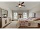 Comfortable main bedroom with a ceiling fan, dresser, and large windows, offering a peaceful retreat at 1423 Chelsea Manor Cir, Deland, FL 32724