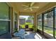 Enclosed patio with ceiling fan offers great views of the backyard and a comfortable seating area at 1423 Chelsea Manor Cir, Deland, FL 32724