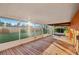 Enclosed back porch with screen and view of large backyard at 1493 Derbyshire Rd, Daytona Beach, FL 32117