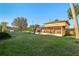Large backyard featuring screened porch, wooden fence, and mature trees at 1493 Derbyshire Rd, Daytona Beach, FL 32117