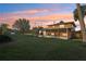 Fenced-in backyard with mature trees and a screened-in patio at 1493 Derbyshire Rd, Daytona Beach, FL 32117