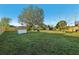 Spacious backyard with large shade trees and full perimeter fence at 1493 Derbyshire Rd, Daytona Beach, FL 32117