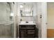 Nicely remodeled bathroom featuring modern vanity and shower with marble tile surround at 1493 Derbyshire Rd, Daytona Beach, FL 32117