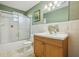 Bathroom features colorful decor including a shower with sliding glass doors and vanity at 1493 Derbyshire Rd, Daytona Beach, FL 32117