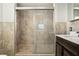Updated bathroom features a modern glass shower with decorative tile surround at 1493 Derbyshire Rd, Daytona Beach, FL 32117