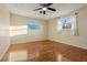 Bedroom featuring hardwood floors, natural light, and ceiling fan for comfort at 1493 Derbyshire Rd, Daytona Beach, FL 32117