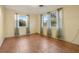 Bedroom showcasing large windows and tile flooring, perfect for relaxation at 1493 Derbyshire Rd, Daytona Beach, FL 32117