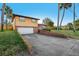 Two-story home with front lawn, driveway, and attached garage at 1493 Derbyshire Rd, Daytona Beach, FL 32117