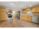 Kitchen with tile flooring, wood cabinetry, stainless appliances, and functional layout at 1493 Derbyshire Rd, Daytona Beach, FL 32117
