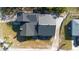 Overhead view of the house showing the roof, driveway, and surrounding landscape at 1572 Darlington Ave, Deltona, FL 32725