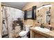 Bathroom with a modern sink, decorative mirror, and a shower with a patterned curtain at 1572 Darlington Ave, Deltona, FL 32725